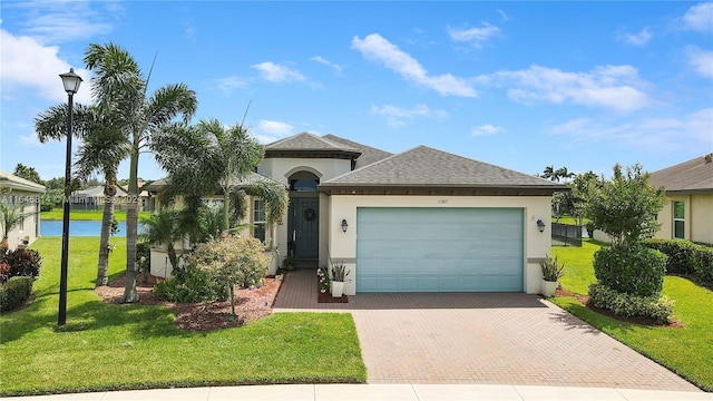 view of front of house with a garage and a front lawn