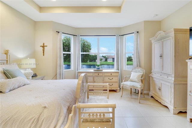 tiled bedroom with a raised ceiling