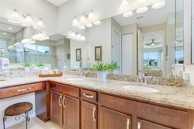 bathroom featuring tile patterned floors, ceiling fan, vanity, and a healthy amount of sunlight