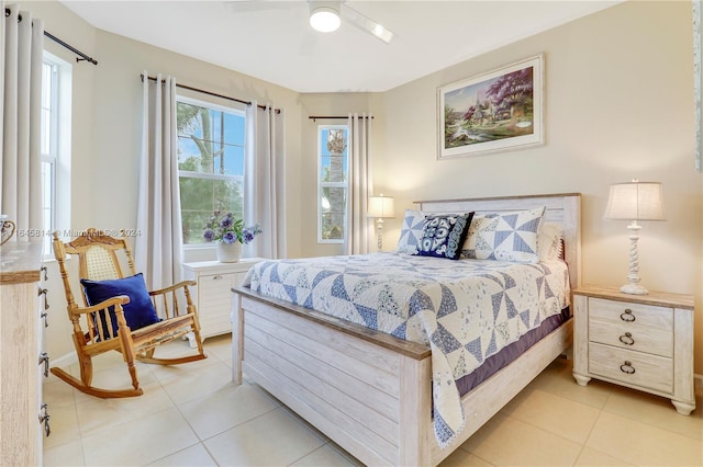 tiled bedroom featuring ceiling fan