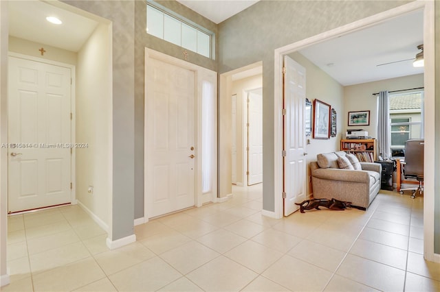 entryway featuring ceiling fan and light tile patterned floors