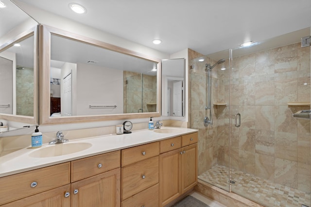 bathroom with vanity and a shower with door