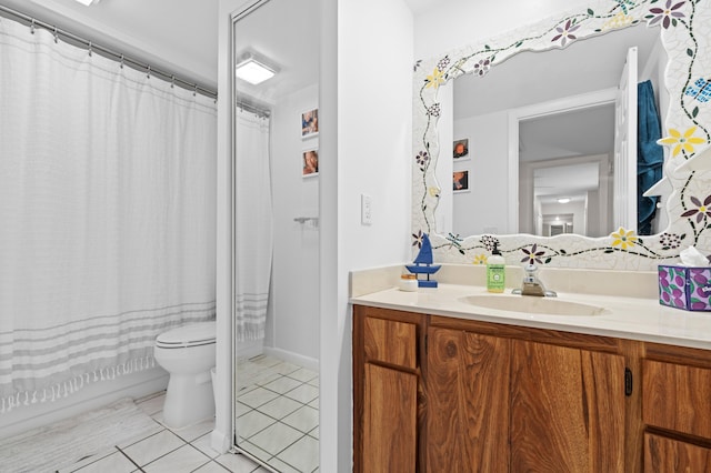 bathroom featuring vanity, tile patterned floors, and toilet