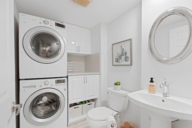 laundry area with sink and stacked washing maching and dryer