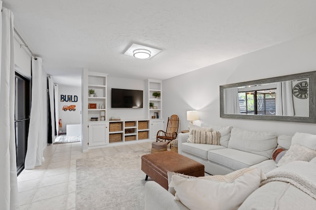 living room featuring light tile patterned floors and a textured ceiling