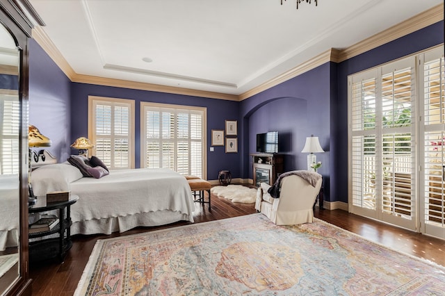 bedroom with dark hardwood / wood-style flooring and crown molding