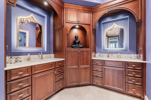 bathroom with tile patterned floors, vanity, and a chandelier