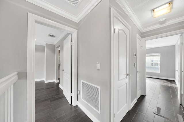 hall featuring a textured ceiling, dark hardwood / wood-style floors, and crown molding