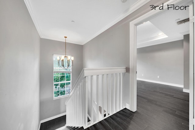 stairs featuring an inviting chandelier, ornamental molding, and wood-type flooring