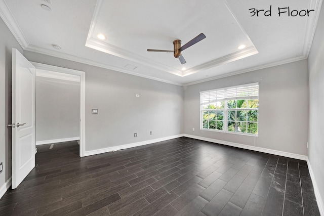 unfurnished room with a raised ceiling, ceiling fan, and crown molding