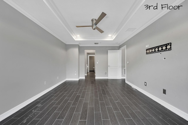 unfurnished room with ceiling fan, a raised ceiling, and ornamental molding