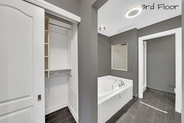 bathroom featuring a relaxing tiled tub