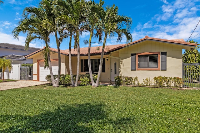 view of front facade with a front yard and a garage