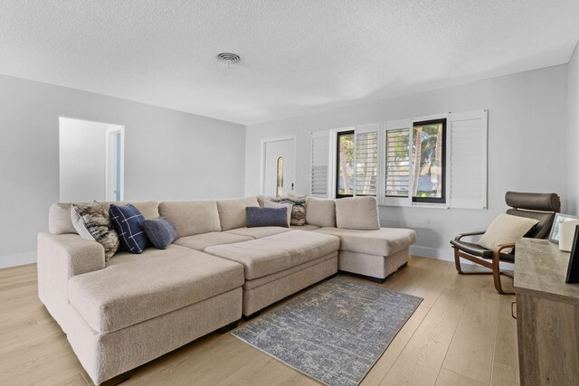 kitchen with white cabinets, light wood-type flooring, appliances with stainless steel finishes, and sink