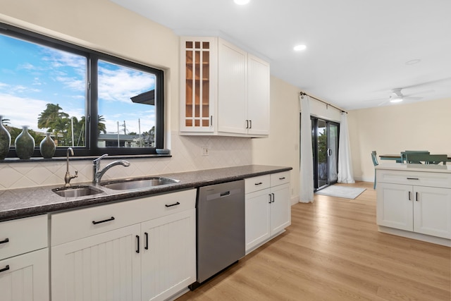 kitchen with light hardwood / wood-style floors, sink, white cabinets, and dishwasher