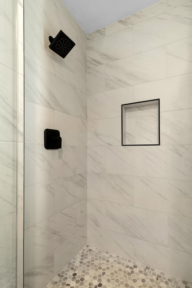 bathroom with a tile shower