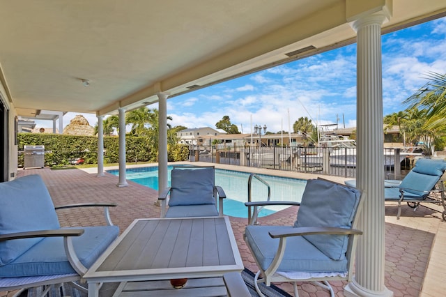 view of pool with a patio area and a grill