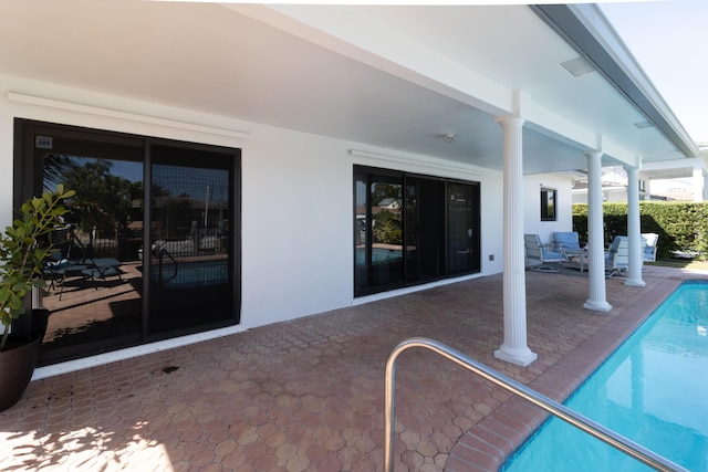 exterior space featuring a patio area, an outdoor pool, and stucco siding