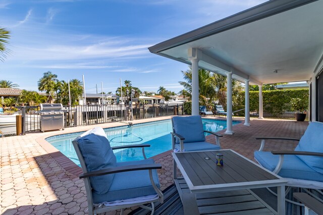 view of patio with a fenced in pool and fence