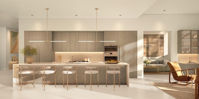 kitchen featuring sink, hanging light fixtures, gray cabinetry, and a breakfast bar area