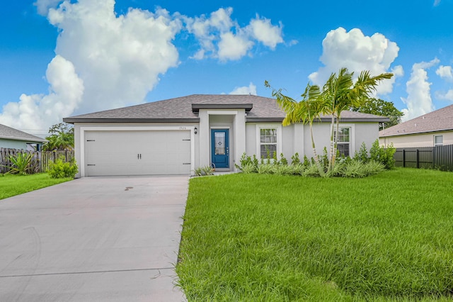 view of front of house featuring a garage and a front yard