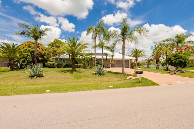 view of front of house with a front yard and a garage