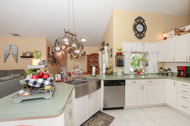 kitchen featuring dishwasher, lofted ceiling, white cabinets, sink, and kitchen peninsula