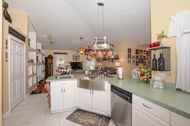 kitchen with kitchen peninsula, ceiling fan, sink, dishwasher, and hanging light fixtures