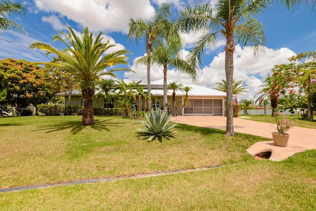 view of front of house featuring a garage and a front lawn