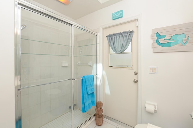 bathroom with tile patterned floors and an enclosed shower