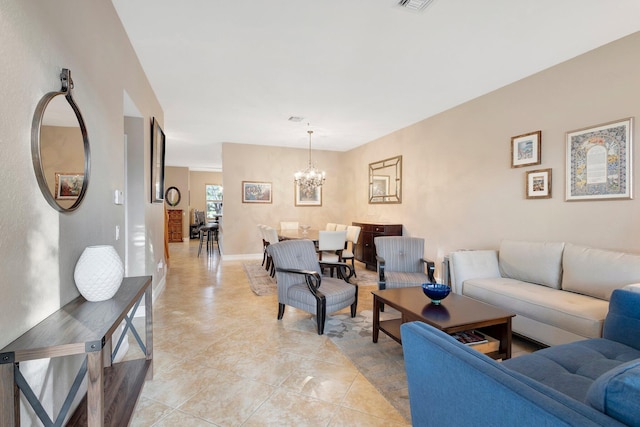 tiled living room with a notable chandelier