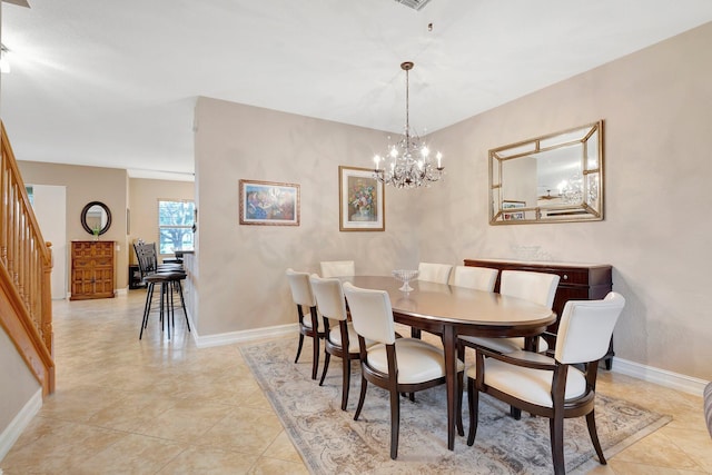 tiled dining space with a chandelier