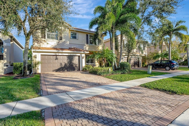 view of front of property with a front yard and a garage