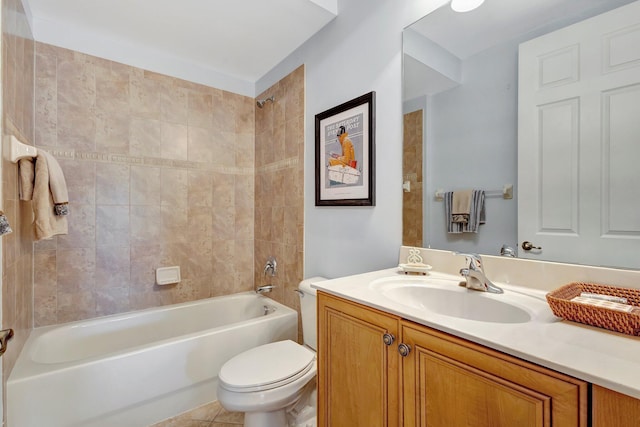 full bathroom featuring toilet, tiled shower / bath, tile patterned floors, and vanity