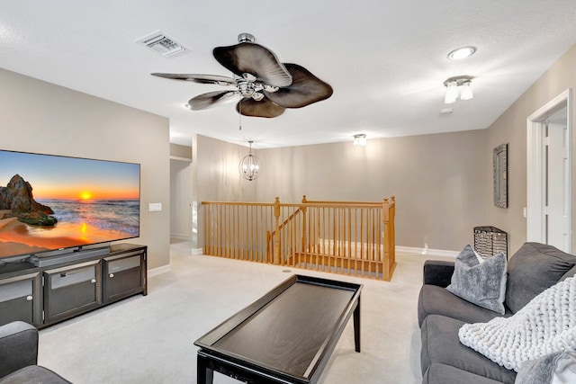 11606 Ponywalk Trl, Boynton Beach, FL 33473 - living area with baseboards, visible vents, light carpet, and ceiling fan with notable chandelier