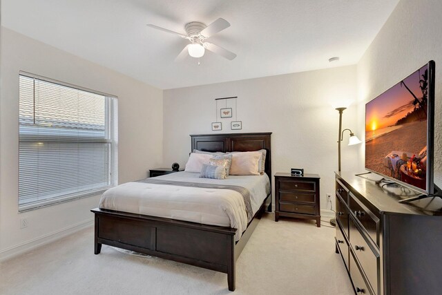 carpeted bedroom featuring ceiling fan and a closet