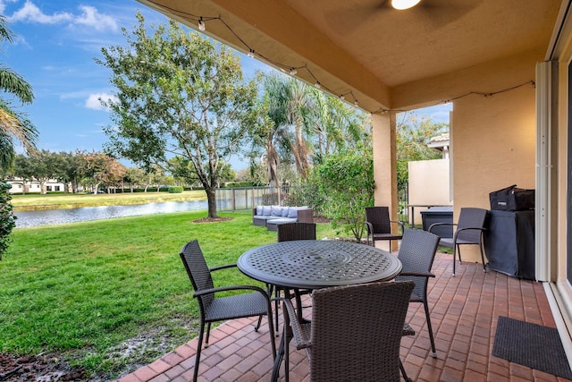 view of patio with a water view and outdoor lounge area