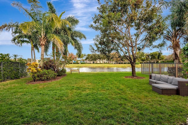 view of yard featuring an outdoor living space and a water view