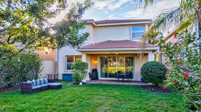 rear view of property with an outdoor living space, a patio area, and a yard