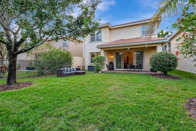 rear view of property with an outdoor hangout area, a patio area, and a yard