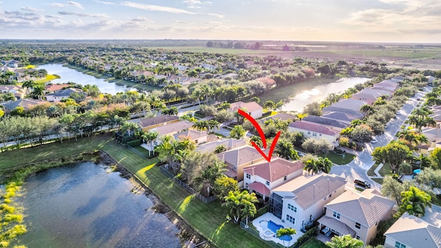 birds eye view of property with a water view