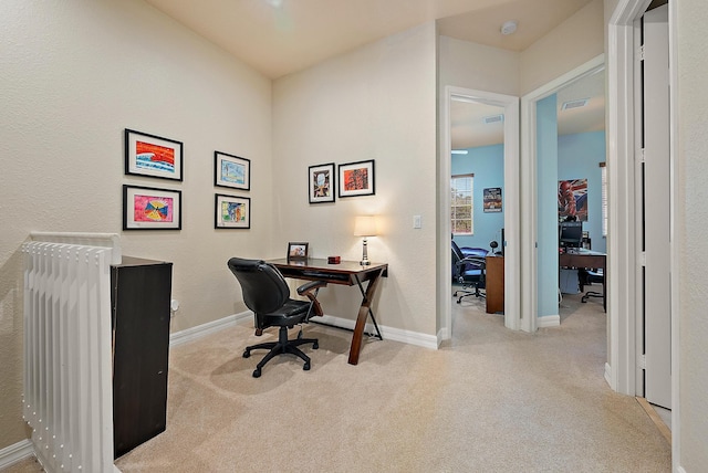 office area featuring light carpet