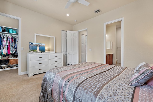 carpeted bedroom featuring ceiling fan and ensuite bathroom