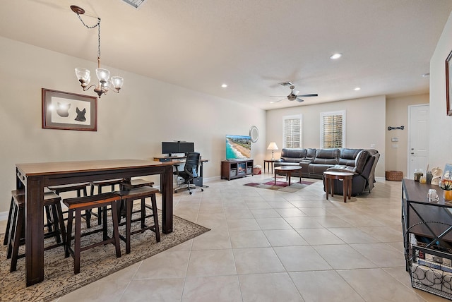 living room featuring light tile patterned floors and ceiling fan with notable chandelier