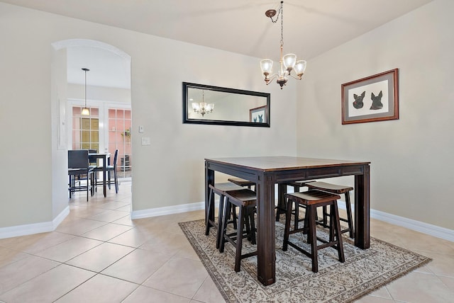 tiled dining area featuring a notable chandelier