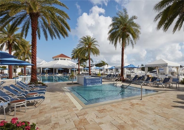 view of pool featuring a gazebo, a community hot tub, a patio area, and pool water feature