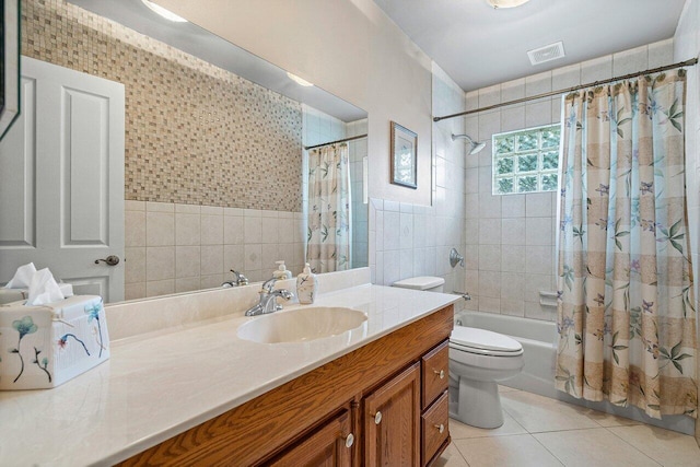 full bathroom with toilet, vanity, tile walls, tile patterned flooring, and shower / bathtub combination with curtain