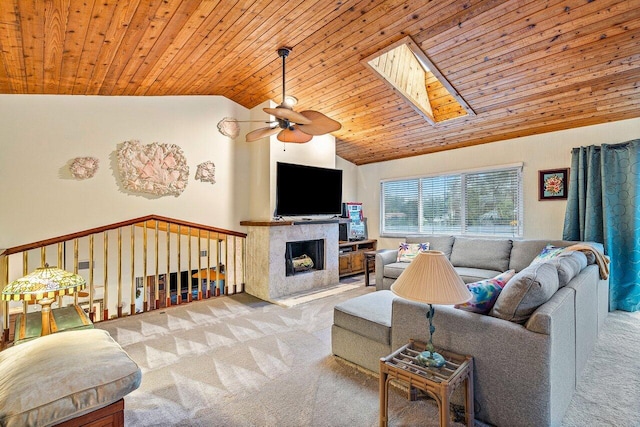 living room featuring light carpet, ceiling fan, a skylight, and wood ceiling