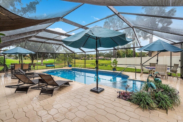 view of swimming pool with glass enclosure, a yard, and a patio