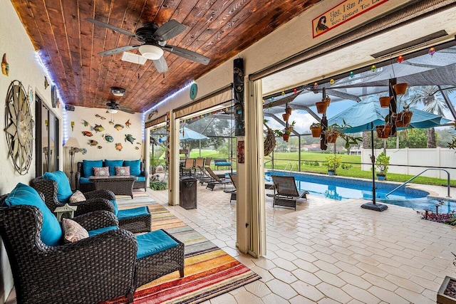 view of patio / terrace with ceiling fan, a fenced in pool, an outdoor living space, and glass enclosure